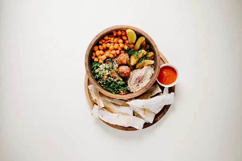 Vegetarian bowl with chickpeas, hummus, tabbouleh and flatbread
